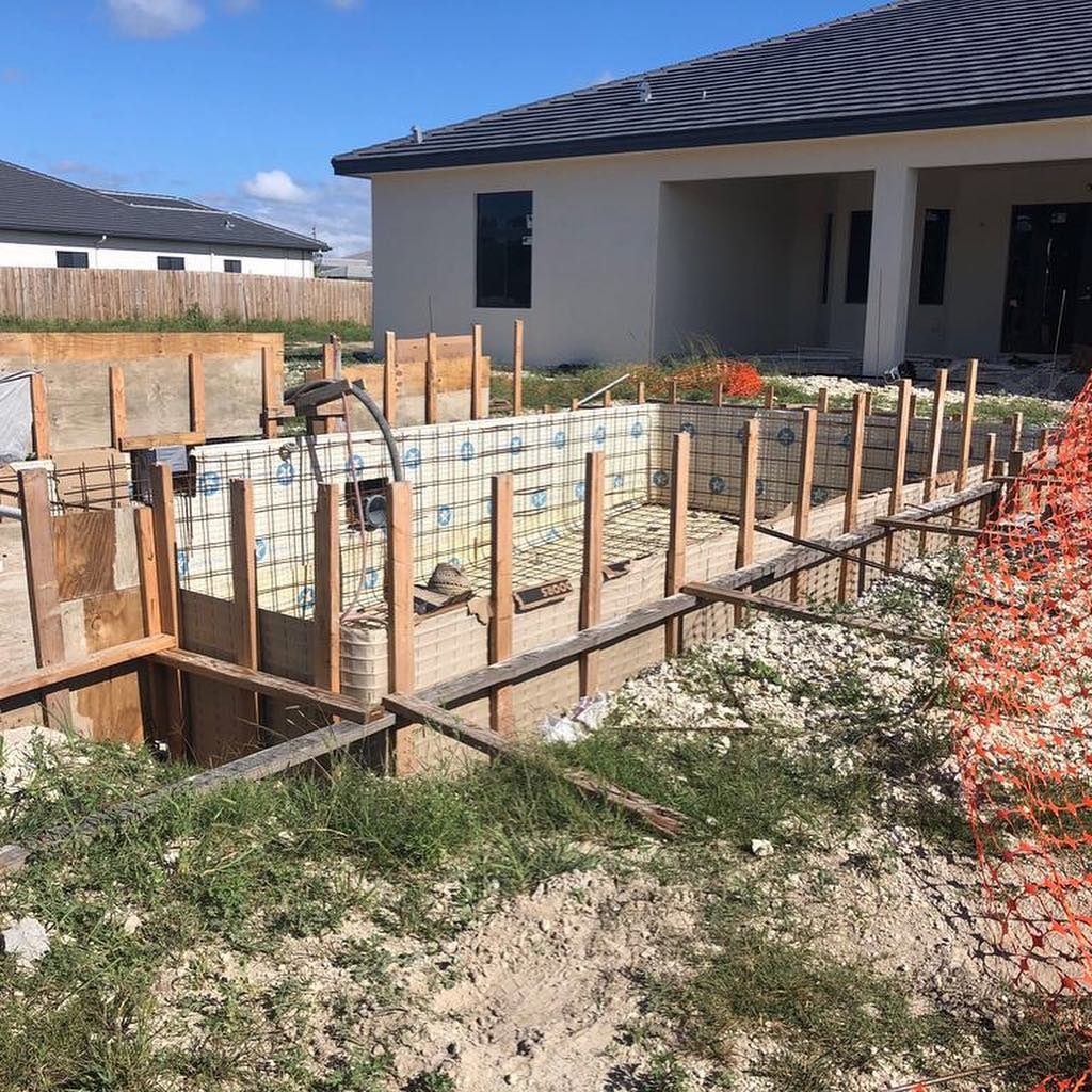 New home under construction with pool forms